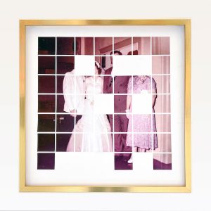 Framed artwork of a family portrait titled Wedding Present which is a series of 48 squares with 8 squares missing. 